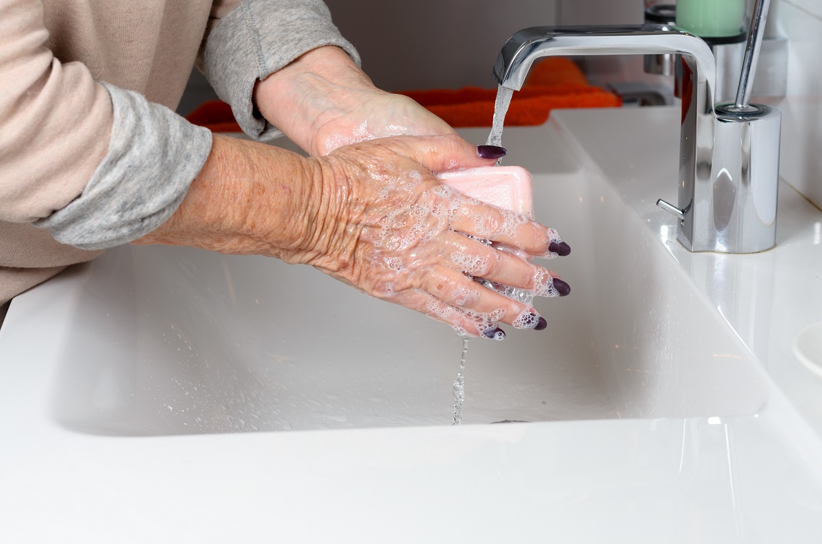 senior washing her hands