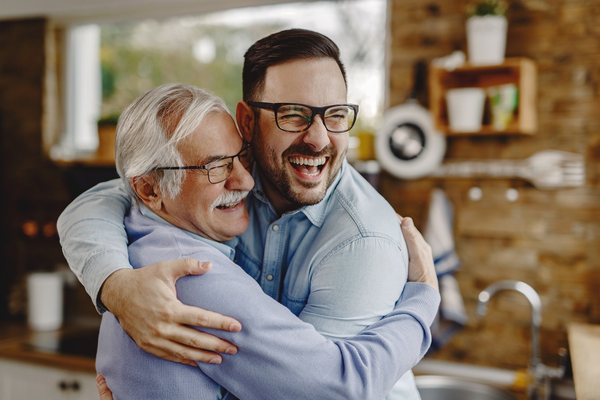 Man embracing senior father in a kitchen