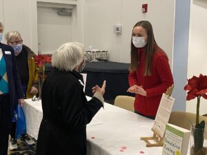 Senior woman speaking to vendor at Heart Health fair