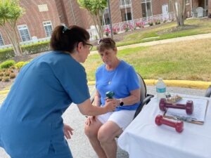 Independent Living resident test fitness skills with a weight. Fitness Festival at The Chesapeake