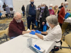 Heart Health Fair by The Chesapeake. Senior woman taking senior man's pulse.