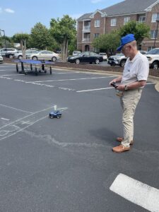 Independent Living male resident plays with remote control car at The Chesapeake Fitness Festival